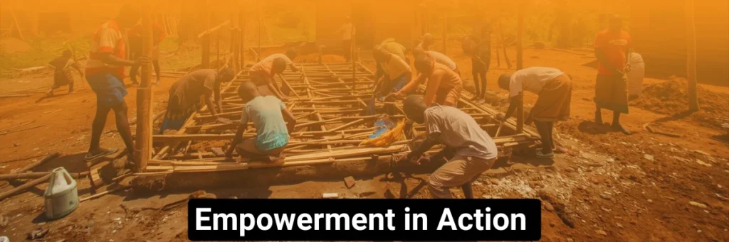 Community members work together on a construction project, lifting materials and building collaboratively. The image symbolizes empowerment in action, reflecting how Baino Social Impact helps communities take ownership of their growth and create lasting change through collective effort and skill-building.
