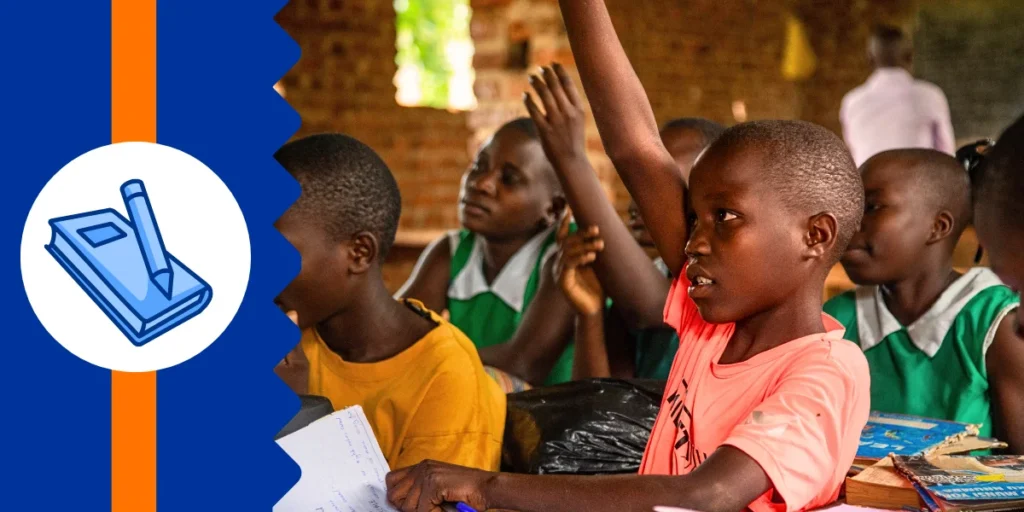 Young schoolchildren in a rural Ugandan classroom raising their hands to answer the teacher’s question — a vibrant symbol of empowered learning made possible through legacy giving.