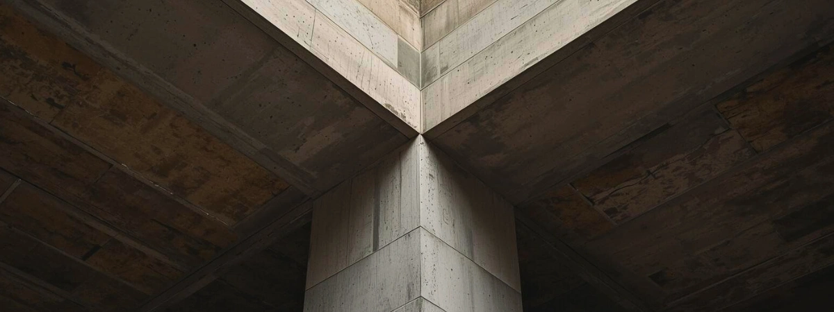 A strong beam at the intersection of large structural pillars, conveying the strength of a unified force in functional infrastructure.