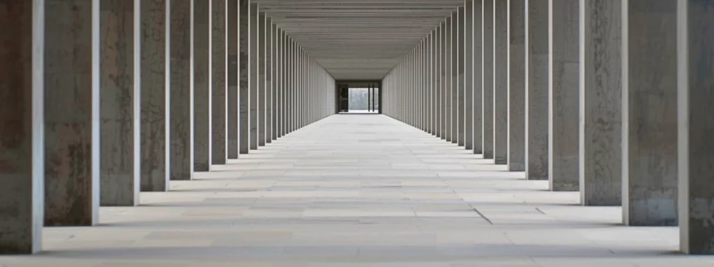 A corridor with repeating structural elements, conveying rhythm, order, and steady continuity.