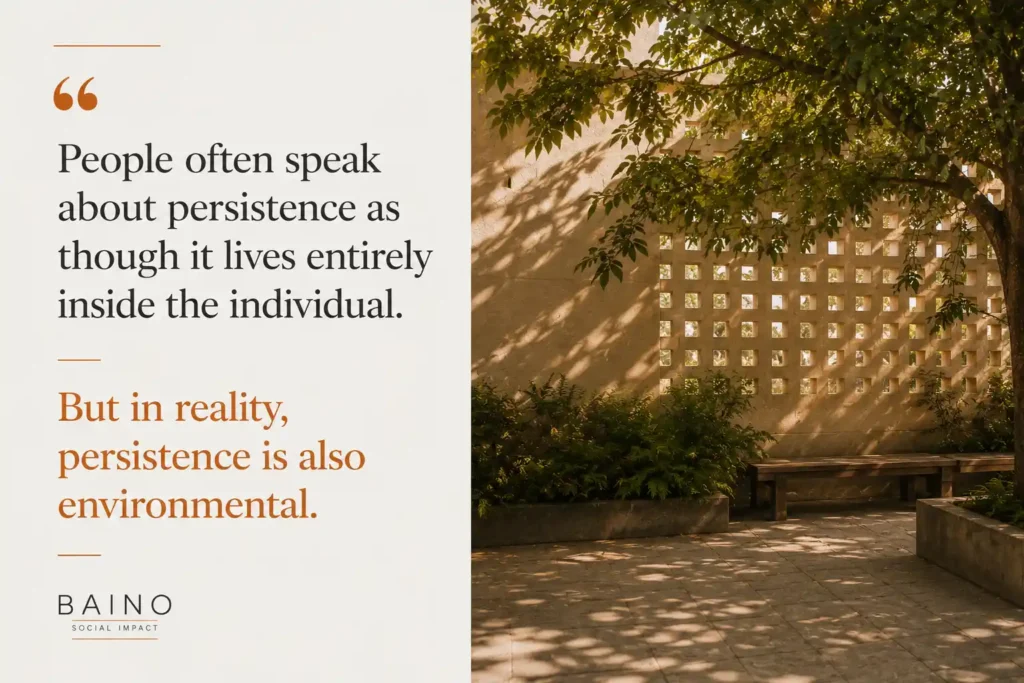 Quote graphic about belonging and culture in education, featuring a quiet communal courtyard with shared seating and natural light, illustrating how persistence is shaped not only by individuals but also by the environments around them.